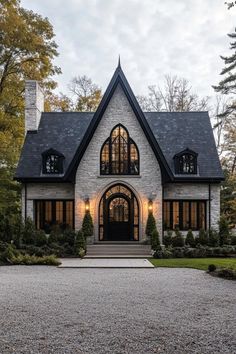 this is an image of a house in the country style with stone and black shingles