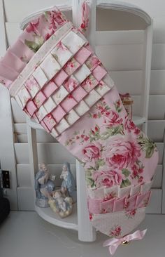 a doll house with pink and white flowers on it