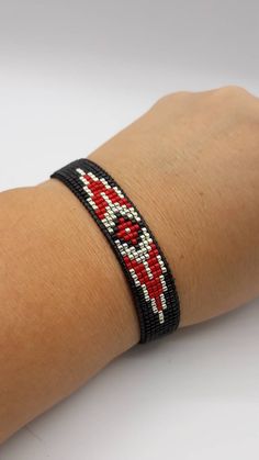 Red Beaded Bracelets With Black Beads For Festival, Black Beaded Bracelets For Gift, Gift Black Beaded Bracelets, Red Bohemian Bracelet With Black Beads, Handmade Black Bangle Friendship Bracelets, Black Wristband With Colorful Beads Gift, Black Handmade Friendship Bracelet, Black Beaded Bracelet With Round Beads, Red Wristband Bracelet With Colorful Beads