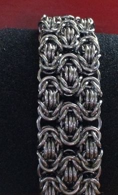 "This handmade chainmaille bracelet is made from heavy stainless steel rings forming the tri- Byzantine chainmaille weave to form a wide cuff bracelet with a sturdy toggle clasp. The bracelet material is slightly heavier than others due to the material that I use but it is very flexible and fluid like and feels fantastic on the wrist. I prefer stainless steel to many other metals because they're sturdy they don't fade and they don't tarnish and they have that oxidized shade instead of being shin Chainmaille Clothing, Chainmaille Weaves, Byzantine Chainmaille, Chainmaille Jewelry Patterns, Chain Maille Patterns, Chainmail Patterns, Chainmail Necklace, Chainmail Jewelry, Chainmaille Bracelet