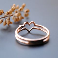 An simple but unique ring with double bands forming a heart in the center and a sparkling diamond on the side. It's you and your better half.. both your hearts :) Details: * Diamond Wt. : 0.01 Carat * Colour Clarity - H I, VS Si * Gold: 2.3 gms, 14kt Solid Rose Gold (Other options available) Rose Gold Love Heart Ring - Diamond Heart Ring - Valentine's Day Gift for Wife - Double Band Lover Ring - Symbol of Love - Gifts for Her -------------------- ** To keep your jewellery looking new, please avo Stackable Rose Gold Heart Ring Fine Jewelry, Rose Gold Double Heart Promise Jewelry, Rose Gold Stackable Heart Ring In Fine Jewelry Style, Elegant Adjustable Heart-shaped Stackable Rings, Rose Gold Stackable Heart Ring For Wedding, Rose Gold Double Band Stackable Rings For Wedding, Elegant Stackable Wedding Rings With Heart Charm, Rose Gold Promise Ring With Open Heart Shape, Anniversary Rose Gold Stackable Heart Ring