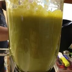 a blender filled with green liquid on top of a counter