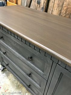 an old dresser has been painted gray