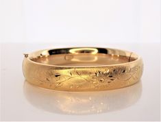 Winard vintage gold cuff. Floral Design. Beautiful domed style cuff. 12K gold filled and probably made in the 1940's. The bracelet is stamped 2 Winard 1/20-12K G.F.  Please view all photos for accurate description and condition. The cuff weighs approximately 20.74grams and is 2.23 inches at the widest inside diameter and is 1 inch wide.  Thank you, Indigo Floral Cuff, Personal Style Inspiration, Gold Cuffs, Gold Bangle Bracelet, Gold Bangle, Gold Bangles, Cute Jewelry, Wedding Stuff, Bangle Bracelet