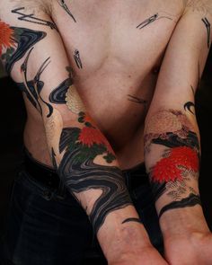 a man with tattoos on his arms and hands