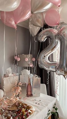 a table with balloons, confetti and other items on it