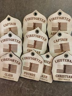 eight firefighter tags with the words, firefighters and flag on them are laid out