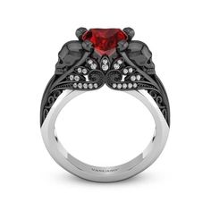 a black and white ring with a red stone in the center, surrounded by diamonds