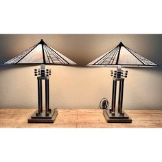 two lamps sitting on top of a wooden table