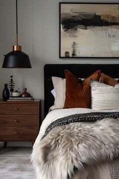 a bedroom with a bed, nightstands and pictures on the wall