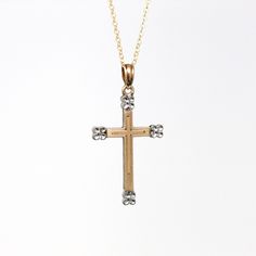 Timeless vintage circa 1940s era 10k yellow & white gold cross necklace! This symbolic pendant is the shape of a yellow gold cross, accented with white gold floral motifs. The vintage charm is shown modeled on a brand new 14k gold filled 20 " chain. A classic piece of fine vintage religious jewelry! *Sale - price reduced from $250 USD to $240 USD.  ERA - Circa 1940s - Retro  MARKINGS / MATERIAL - 10k yellow & white gold pendant, 14k gold filled chain  MARKINGS / HISTORY - Back of pendant is marked "10k" with indecipherable markings  CONDITION - Good vintage condition. Yellow & white gold metal has been professionally polished & cleaned. Age appropriate patina & wear remains. Amazing vintage cross necklace!  SIZE / MEASUREMENTS - Chain Modeled: 20 inches, Pendant (including bail): 1 1/4 x 5 Classic Diamond Cut Cross Necklace, Classic Crucifix Cross Necklace For Anniversary, Classic Diamond Cut Crucifix Necklaces, Classic Diamond Cut Crucifix Necklace, Antique Cross Pendant Necklace For Formal Occasions, Victorian Cross Necklace For Formal Occasion, Classic Cross Pendant Necklace For Anniversary, Antique Yellow Gold Crucifix Jewelry, Vintage White Cross Jewelry