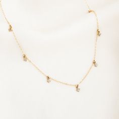 Our Dangling Stardust Necklace is the necklace you never knew you needed until now. Each delicate charm has four sparkly stones that will shimmer at every angle - it'll make you feel so feminine and pretty! It's the perfect standalone everyday necklace, and also layers beautifully with your other favorites. DETAILS 14k gold filled chain, clasp, & findings 14k gold vermeil 4mm charm Necklace length: 14" with 2" extender Safe for sensitive skin & shower safe Matching jewelry: Tiny Stardust Thread Dainty Necklaces, Daisy Necklace, Gold Filled Ring, Matching Jewelry, Everyday Necklace, Christmas 2022, Dainty Bracelets, Women's Jewelry And Accessories, Birthstone Charms