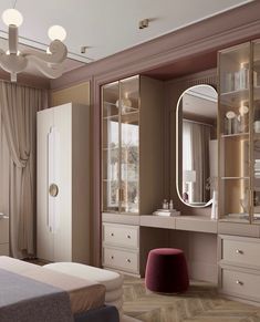 a bedroom with a bed, dressing table and mirror on the wall next to it