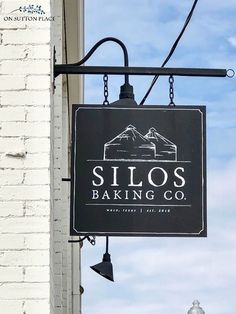 a sign hanging from the side of a building that says silo's baking co