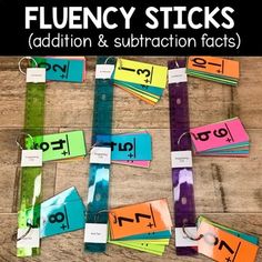 an array of flueny sticks with addition and subtraction tags