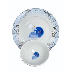 two white plates with blue and gold designs on the rims, one has an image of a woman holding a baby