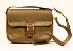 A vintage Gucci crossbody bag. The bag is made of olive green leather with green suede application at the front flap, and gold toned hardware. The interior is lined with brown leather and next to the major compartment it features one side zipped pocket and one side slip pocket. The bag is in very good vintage condition with hardly any signs of use, please notice that there is an ink stain in the inner right corner. The max. length of the shoulder strap is: 120 cm. It comes with its original Gucc Green Business Satchel With Gold-tone Hardware, Green Leather-lined Shoulder Bag For Business, Green Leather Lined Shoulder Bag For Business, Green Formal Flap Bag With Adjustable Strap, Formal Green Flap Bag With Adjustable Strap, Classic Green Flap Bag For Travel, Vintage Green Leather Satchel, Vintage Green Satchel For Formal Occasions, Green Evening Bag With Flap