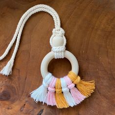 a wooden table with a white rope and multicolored tassels hanging from it