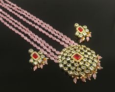 This is a stunning handmade necklace perfect for high end Jewelry Collector, a keeper in Traditional Vintage Indian/Pakistani Bridal jewelry and a Luxury Gift for your Daughter, Sister or Wife on Wedding or Anniversary. Perfect for any type of occasions, weddings And celebrations and a beautiful & memorable gift for weddings and special occasions. -Item Code:- L9706 -Pink Monalisa Rajwada Necklace Set with Earrings. -Designer pink beaded necklace with Polki Diamond pendant. -Gold Plated Set with Kundan Stones which shine like polki. -Metal: Gold plated brass -Earrings are 43mm long and 30mm wide -Push Back Earrings -Necklace length with pendant 12" approx excluding dori/cord -Quantity:- One Necklace Set Please see more different designs here:- https://www.etsy.com/in-en/shop/LUCKYJEWELSART Polki Diamond Necklace, Trendy Bridesmaids, Pink Beaded Necklace, Pakistani Bridal Jewelry, Rani Haar, Diamond Necklace Set, Gemstone Beaded Necklace, Pink Beaded, Bridesmaid Necklace