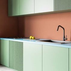 a kitchen with green cabinets and a sink