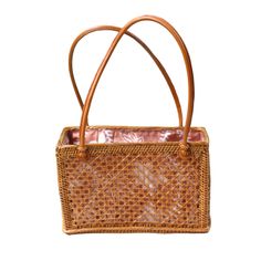 Rattan Top Handle Shoulder tote is the perfect addition to your bag collection. Features a fully lined drawstring closure batik print 100% cotton lining. Perfect to carry your keys, wallet, phone and other essentials. (PRODUCT INFO): Material: Rattan/Ata Size: 6" H x 9" L x 4" D inches Fully lined interior-100% cotton batik print Drawstring closure (SHIPPING INFO): All our items are made-to-order, therefore please allow 3-5 business days for production. Our goal is to become more sustainable throughout our production process, reducing overproduction and maintaining responsible stock levels. Thank you for your patience in supporting our mission. Thank you for choosing to support sustainable shopping! We value your support. Casual Rectangular Bucket Bag With Phone Pocket, Square Bucket Bag For Travel With Mobile Phone Bag, Square Travel Bucket Bag With Mobile Phone Pocket, Square Travel Bucket Bag With Mobile Phone Bag, Daily Use Beach Tote With Mobile Phone Bag, Brown Rectangular Bucket Bag For Travel, Everyday Rectangular Shoulder Bag With Bamboo Handle, Light Brown Rectangular Shoulder Bag With Removable Pouch, Brown Rectangular Bucket Bag