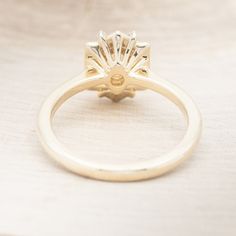 a yellow gold ring with a diamond center