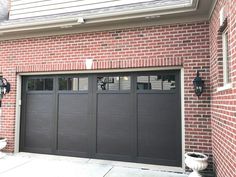 a brick building with two garage doors on each side and one door open to let in light