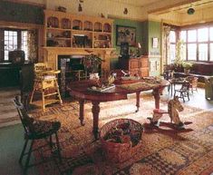 a living room filled with furniture and lots of windows next to a fire place on top of a rug