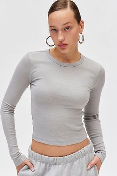 Staple BDG long sleeve tee in a slim & cropped silhouette. Too perfect basic t-shirt style in a soft & stretchy knit featuring a crew neckline, slim long sleeves and ribbed knit trim designed to be your new go-to. Only at Urban Outfitters. Features BDG Too Perfect long sleeve tee Fitted long sleeve top Soft and stretchy knit Perfect basic long sleeve tee in our fave colors and prints Crew neckline and long sleeves with ribbed knit trim Ribbed knit trimmed hem Slim bodycon fit Cropped length Easy Fitted Long Sleeve Top, Basic Long Sleeve Tee, Fitted Long Sleeve, Small Chest, Exclusive Collection, Long Sleeve Tee, Crew Neckline, Long Sleeve Top, Shirt Style