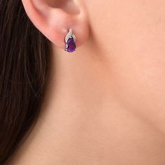 Appeal to her sophisticated taste with these exciting gemstone drop earrings. Created in sterling silver, each graceful earring showcases a 7.0 x 5.0mm pear-shaped bright purple amethyst beneath a flame-inspired design of overlapping ribbons adorned with sparkling diamond accents and beaded detailing. Buffed to a brilliant luster, these post earrings secure comfortably with friction backs. Luxury Amethyst Teardrop Earrings, Formal Briolette Earrings With Gemstone Accents, Luxury Silver Teardrop Earrings As Gift, Luxury Silver Teardrop Earrings For Gift, White Gold Teardrop Pendant Earrings For Formal Occasions, Luxury Cubic Zirconia Teardrop Earrings Gift, Elegant Teardrop Pear-shaped Earrings With Prong Setting, Elegant White Gold Teardrop Pendant Earrings, Elegant Briolette Teardrop Earrings