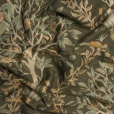 the fabric is green and brown with flowers on it, as well as leaves and branches