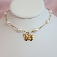 The Flutter Pearl Choker features a delicate butterfly pendant, crafted from high-quality stainless steel with a gold finish and accented with shimmering AAA pearls. The choker is fully adjustable for a comfortable fit on any neck size. Hypoallergenic and gentle on sensitive skin, it combines quality materials with a unique design for those who value both style and comfort. * Stainless Steel * Skin-friendly * AAA 8mm freshwater pearls * Waterproof * Pendant- 13mm x 22mm * Adjustable  * Lobster c Gold Metal Butterfly Necklace, Gold Adjustable Butterfly Necklace With Clavicle Chain, Adjustable Gold Butterfly Necklace With Clavicle Chain, Elegant Butterfly Charm Choker Jewelry, Butterfly Choker Necklace With Clavicle Chain For Gift, Wedding Butterfly, Wings Necklace, Delicate Butterfly, Choker Gold