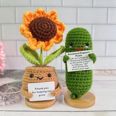 two small crocheted items sitting next to each other on top of a table