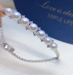 Cute Akoya Pearl Bangle, 5.5-6mm, Seven Beautiful Bright White Color, Very High Luster.  Sterling Silver S925 with sparkling cubic zircons, Very Well made and Comfortable to wear.  Stunning and Elegant   Lustrous Beauty   Pearls ★ Pearl: Genuine Akoya Pearls, Saltwater, Japan ★ Size: 5.5-6mm ★ Shape: Round ★ Color: Natural untreated, Bright White with light pink overtone, Beautiful ★ Luster: Very High Luster, Wonderful ★ Surface: Nice, Mirror Like, gentle texture, Mostly Very Clean Bangle/Bracelet ★ Metal: Sterling Silver S925 with sparking cubic zircons. Very well made, Elegant and Stunning 🤩 Shipping FREE with USPS First Class in US. Silver Cubic Zirconia Pearl Bracelet For Anniversary, White Pearl Diamond Bracelet For Anniversary, White Diamond Pearl Bracelet For Anniversary, Green Pearl Ring, Green Pearl Earrings, Grey Pearl Earrings, Pearl Pendant Earrings, Pearl Bangle, Stud Jewelry