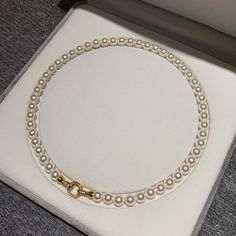 Elevate any outfit with our Classic Round Pearl Necklace for Women! This stunning necklace is the perfect gift for the special woman in your life. The timeless design boasts a round pearl that will add a touch of elegance and sophistication to any look. Show her how much she means to you with this beautiful necklace. Color: White, GrayMaterial: 18K White Gold Plated Copper Stone: Cubic ZirconiaPearl: High Quality Artificial Round PearlPearl Size: 8mm~9mmLength: 45cm ~ 17InchThis necklace is made of 8mm round pearls, which are strung on a silk thread. The pearls are a classic white color and have a high luster. The necklace is 18 inches long and has a sterling silver clasp. Classic Pearl White Necklace With Clavicle Chain, Elegant Round Pearl Necklace For Gift, Pearl Clavicle Chain Necklace, Classic Clavicle Chain Necklace With Round Beads, Classic Necklaces With Clavicle Chain And Round Beads, Classic Clavicle Chain Necklaces With Round Beads, Classic Round Pearl Necklace With Clavicle Chain, Pearl White Round Pearl Necklace, Pearl White Clavicle Chain Necklace