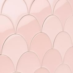 a close up view of a pink wall with wavy lines and circles on the surface