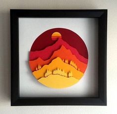 an image of a paper cut landscape in a frame