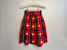 "Absolutely adorable! Here we have a 60s vintage MOD skirt in red, blue, yellow and white bold floral print.  Fitted at the waist and flared. Skirt is gathered at the waistband with large pleats -- secured using two snaps. Metal zipper located in the back.  Dimensions:  Length: 21.5: Waist: 25\" Condition:  Excellent. No visible stains, rips, runs or tears." Retro Red Summer Skirt, Vintage Red Floral Print Skirt, Red Vintage Floral Print Skirt, Fitted Skirt With Retro Print For Spring, Retro Red Skirt For Spring, Retro Floral Print Cotton Skirt, Vintage Retro Print Skirt For Spring, Retro Spring Pleated Skirt, Vintage Skirt With Retro Print For Spring