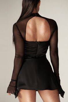 Our 'Maya' mini dress is so fun and flirtatious, making it perfect for romantic date nights. Made from our soft silk satin in a black hue, 'Maya' is cut on the bias and has so many pretty details. The cross front halter shape is so flattering and creates a skin baring open front with a beautifully draped cowl neckline, fitted with our incredible corsetry boning to really cinch the waist.The dramatic sleeves have flared cuffs and 'Maya' is fully lined for comfort, with a zip and button fastening Formal Mini Dress With Fitted Bodice And Boning, Satin Mini Dress With Boning For Cocktail, Spring Fitted Satin Dress With Back Opening, Fitted Satin Dress With Back Opening For Spring, Satin Stretch Dress With Back Zipper, Flirty Mini Dress With Back Zipper, Formal Mini Dress With Boning, Stretch Satin Mini Dress, Mini Dress With Boning For Date Night