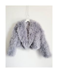 This is gorgeous fluffy feather coat. Luxurious soft feathers and super lightweight and adds a touch of Hollywood glam to your outfit, wedding or other special occasion. Each piece is made to order vintage style with pockets. Comes with a cotton dust bag.  All Colours Available. Please see Chart. No closure. This piece is high quality and gorgeous. It is designed in a classic vintage style and developed and manufactured in collaboration with an atelier. Your item will be shipped with unique care Long Sleeve Feathered Outerwear For Fall, Long Sleeve Feather Outerwear For Fall, Chic Long Sleeve Feathered Outerwear, Faux Fur Outerwear With Feather Trim And Long Sleeves, Faux Fur Long Sleeve Outerwear With Feather Trim, Elegant Winter Feathered Outerwear, Elegant Winter Outerwear With Feathers, Winter Fur Coat With Feather Trim And Long Sleeves, Long Fur Coat With Feather Trim For Winter