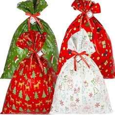 three bags with different designs on them and bows tied around the top one bag is red, green, and white