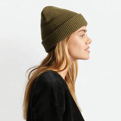 An olive green knit beanie with plush acrylic and has a folding cuff detailed with a woven label. Solid Color Beanie For Fall, Solid Color Fall Beanie One Size, Trendy Knitted Hats For Fall, Soft Knit Snug Hat For Fall, Trendy Knitted Fall Hats, Lightweight Winter Beanie, Knitted Fall Hats For Everyday, Knitted Hat For Everyday Fall Wear, Knit Hat For Everyday Fall Wear