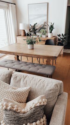 a living room filled with furniture and a wooden table