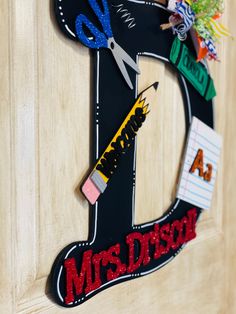 the letter k is decorated with school supplies