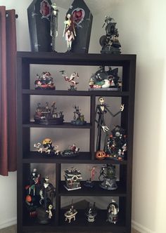 a book shelf filled with lots of halloween figurines