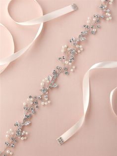 the bridal sash is adorned with pearls and crystals