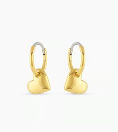 The Lou Heart Huggie Earrings are a beautiful statement piece. Crafted from gold-plated metal, these huggie earrings are the perfect addition to any jewelry collection thanks to their timeless design. 1/2" profile diameter Heart charm measures 5/16" by 3/8" Hinge closure Available in 18k gold plated brass Avoid contact with anything containing derivatives of alcohol Tarnish Resistant Heart Huggie Earrings, Tarnish Resistant Huggie Heart Earrings, Everyday Gold-tone Huggie Earrings, Heart Charm Small Hoop Jewelry For Anniversary, Double Heart Huggie Earrings, Small Hoop Jewelry With Heart Charm For Anniversary, Everyday Double Heart Huggie Earrings, Hypoallergenic Heart Shaped Huggie Earrings, Dainty Tarnish-resistant Huggie Heart Earrings