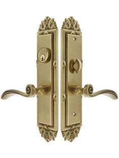 an ornate brass door handle on a white background