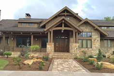 a large house with stone and wood accents