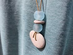 Handmade, one of a kind, beach stone necklace inspired by the beauty of nature. It's a little piece of the beach for you to hold onto and wear all year round. It will also make a lovely gift for anyone who loves being reminded of the peaceful feeling that comes from a walk along the beach or through the woods. All stones are "perfectly imperfect", just as you would find them in nature and are not treated or polished. Materials for this item: natural beach stones, recycled glass beads, waxed cotton cord (tan).  Necklace cords are made from waxed cotton and measure approximately 34"-36" long. Cord is very strong and has a simple tie knot that you can shorten easily. All pieces are handmade in my home shop in Massachusetts and shipped in a lovely little gift bag. I recycle and reuse packaging Adjustable Recycled Glass Necklaces For Beach, Handmade Ocean-inspired Sea Glass Necklaces, Unique Handmade Sea Glass Necklaces, Handmade Unique Necklace With Sea Glass, Handmade Bohemian Sea Glass Necklaces, Unique Recycled Glass Necklaces For Beach, Handmade Bohemian Sea Glass Necklace, Unique Recycled Glass Beach Necklace, Ocean-inspired Sea Glass Necklaces For Beach